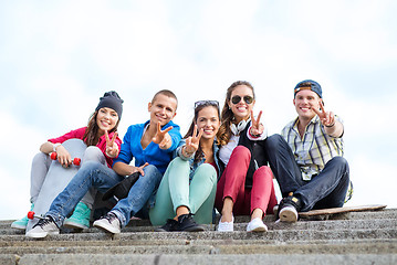 Image showing group of teenagers showing finger five