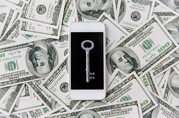 Image showing close up of smartphone with key and dollar money