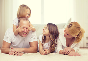 Image showing parents and two girls lying on floor at home