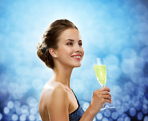 Image showing smiling woman holding glass of sparkling wine