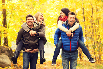 Image showing smiling friends having fun in autumn park