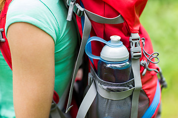 Image showing close up of woman with water bottle in backpack