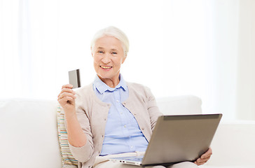 Image showing senior woman with laptop and credit card at home