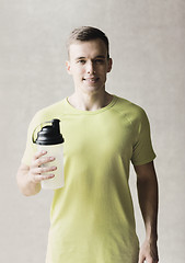 Image showing smiling man with protein shake bottle