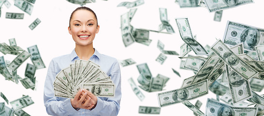 Image showing smiling businesswoman with dollar cash money