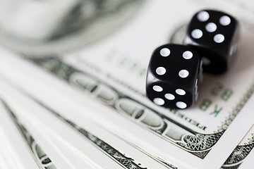 Image showing close up of black dice and dollar cash money