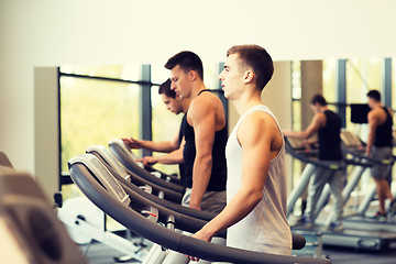 Image showing group of men exercising on treadmill in gym