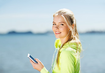 Image showing woman listening to music outdoors