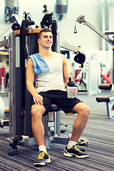 Image showing smiling man exercising on gym machine