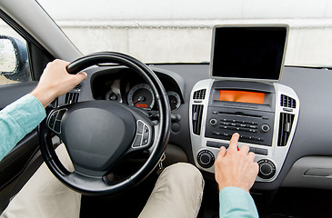 Image showing close up of young man with tablet pc driving car