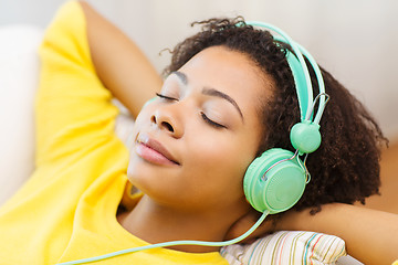 Image showing happy woman with headphones listening to music