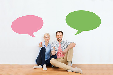 Image showing happy couple showing thumbs up at new home