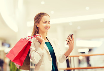 Image showing woman with smartphone shopping and taking selfie