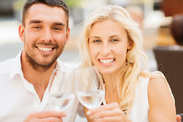 Image showing happy couple clinking glasses at restaurant lounge