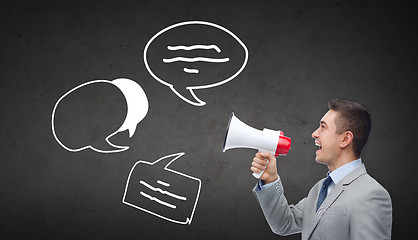 Image showing happy businessman in suit speaking to megaphone