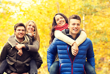 Image showing smiling friends having fun in autumn park