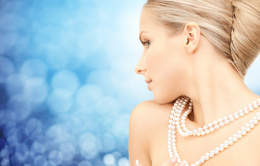 Image showing beautiful woman with sea pearl necklace over blue
