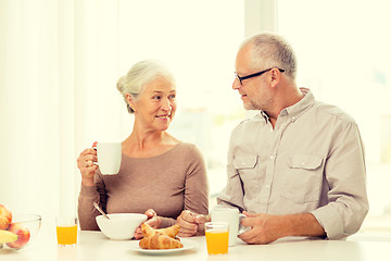 Image showing happy senior couple having breakfast at home