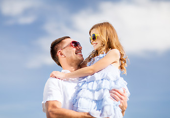 Image showing happy father and child in sunglasses over blue sky