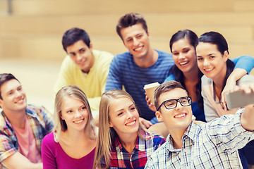 Image showing group of students with smartphone and coffee cup