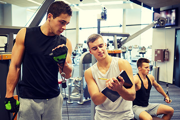 Image showing men exercising on gym machine