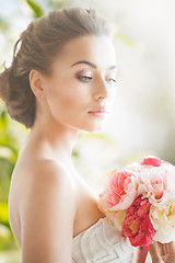 Image showing young woman with bouquet of flowers