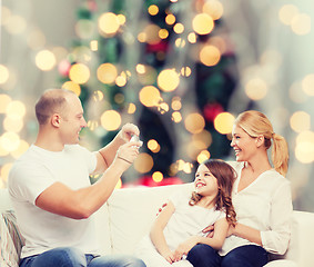 Image showing happy family with camera at home