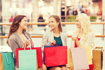 Image showing happy young women with shopping bags in mall