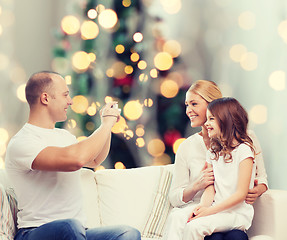 Image showing happy family with camera at home