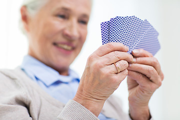 Image showing close up of happy senior woman playing cards