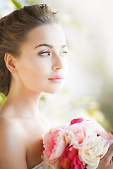 Image showing young woman with bouquet of flowers