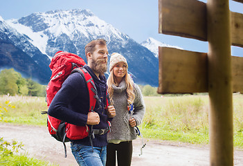 Image showing smiling couple with backpacks hiking