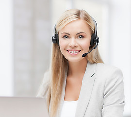 Image showing friendly female helpline operator with laptop