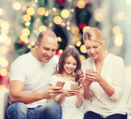 Image showing happy family with smartphones