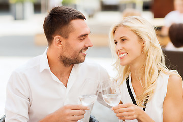 Image showing happy couple clinking glasses at restaurant lounge