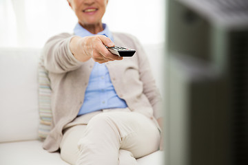 Image showing close up of happy senior woman watching tv at home