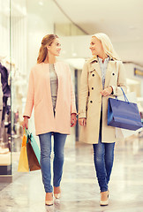 Image showing happy young women with shopping bags in mall