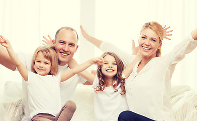 Image showing smiling parents and two little girls at new home