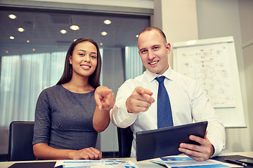 Image showing smiling businesspeople with tablet pc in office