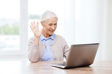 Image showing senior woman with laptop having video chat at home