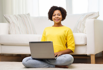 Image showing happy african american woman with laptop at home