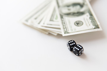 Image showing close up of black dice and dollar cash money