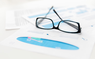 Image showing close up of eyeglasses and files on office table