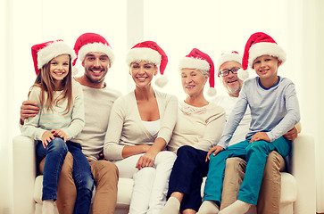 Image showing happy family sitting on couch at home