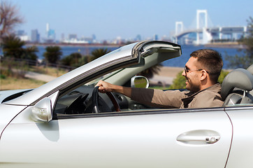 Image showing happy man driving cabriolet car in tokyo