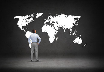 Image showing businessman looking at world map