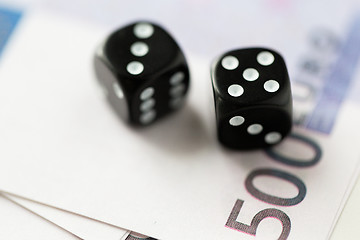 Image showing close up of black dice and euro cash money