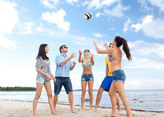 Image showing group of happy friends playing beach ball