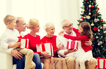 Image showing smiling family with gifts at home