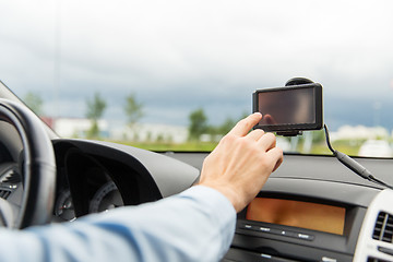 Image showing close up of man with gps navigator driving car